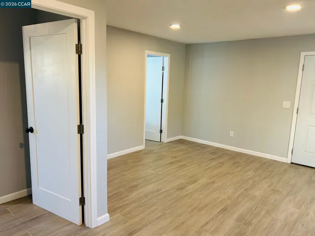 a front view of a house with a tree