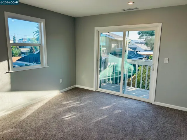 an empty room with wooden floor and a window