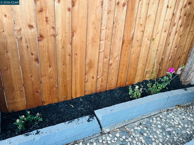 a kitchen with a refrigerator sink and cabinets