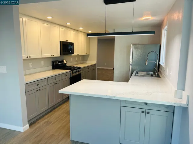 a kitchen with a refrigerator a sink and cabinets