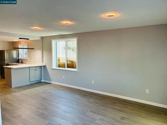 a view of a room with wooden floor and bathroom view