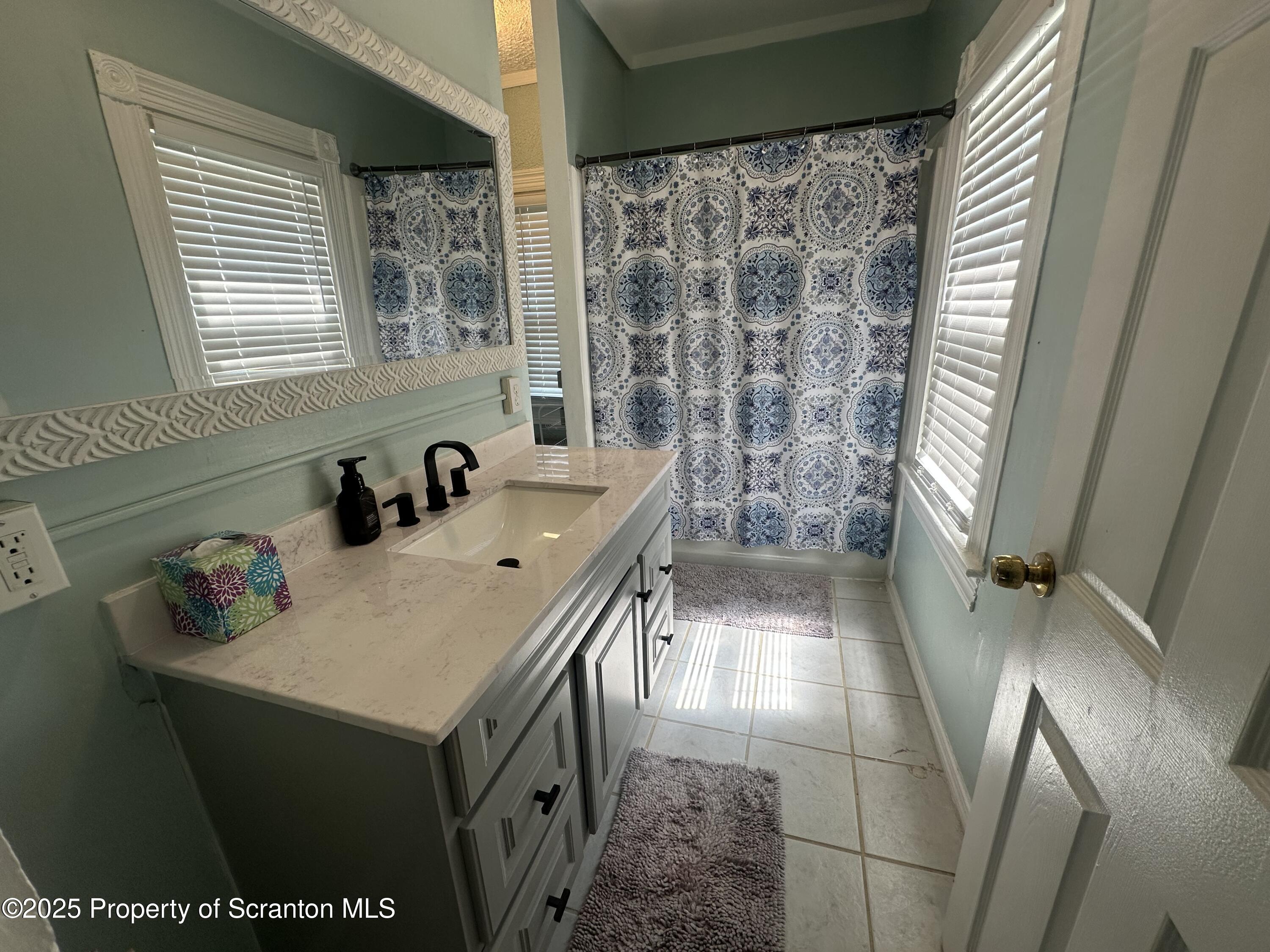 821 Maple Street Scranton, PA 18505 - Photo 15 of 21 a bathroom with a sink and a shower
