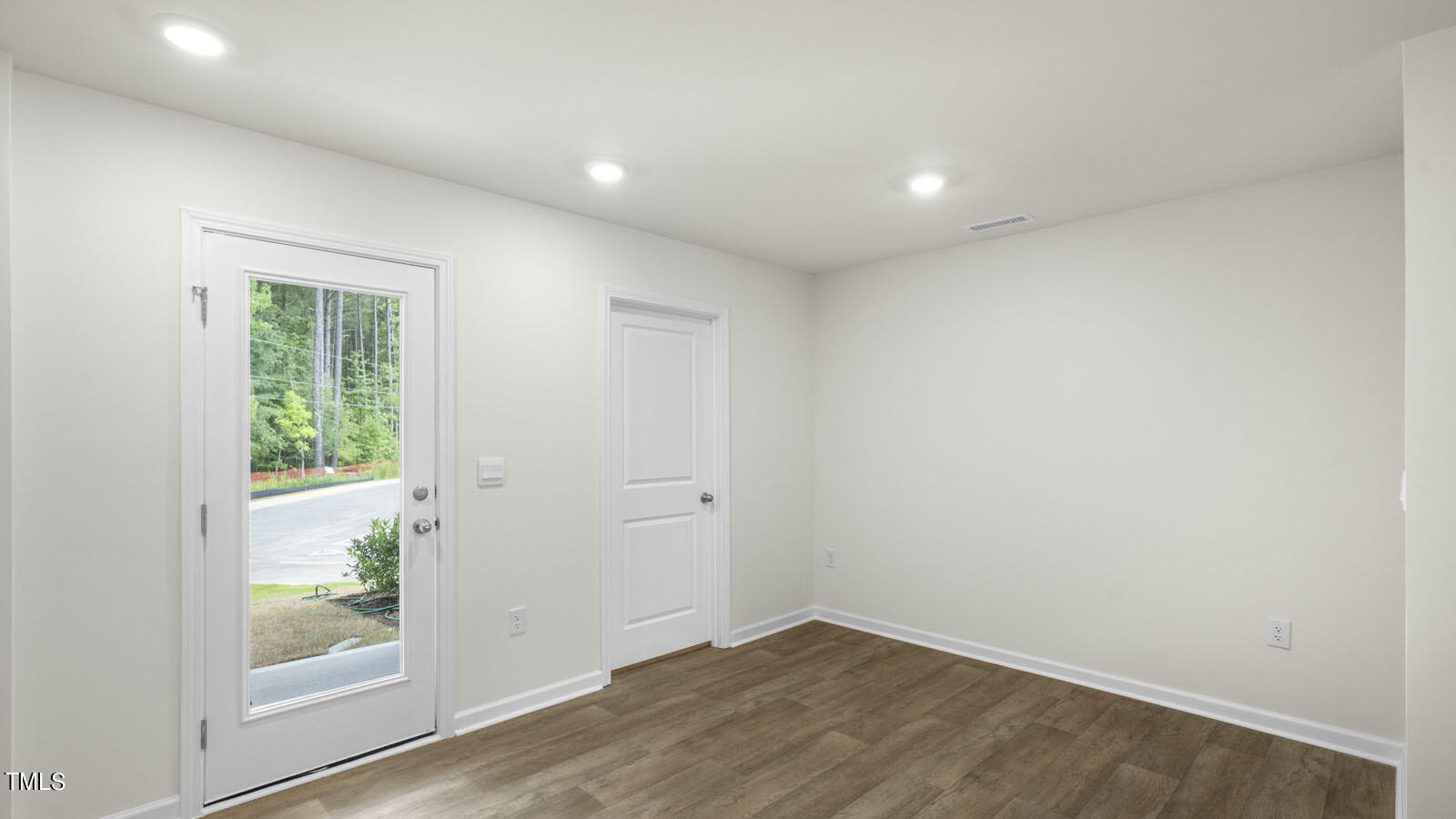 8741 Asher Gray Way Raleigh, NC 27616 - Photo 32 of 49 an empty room with wooden floor and a window