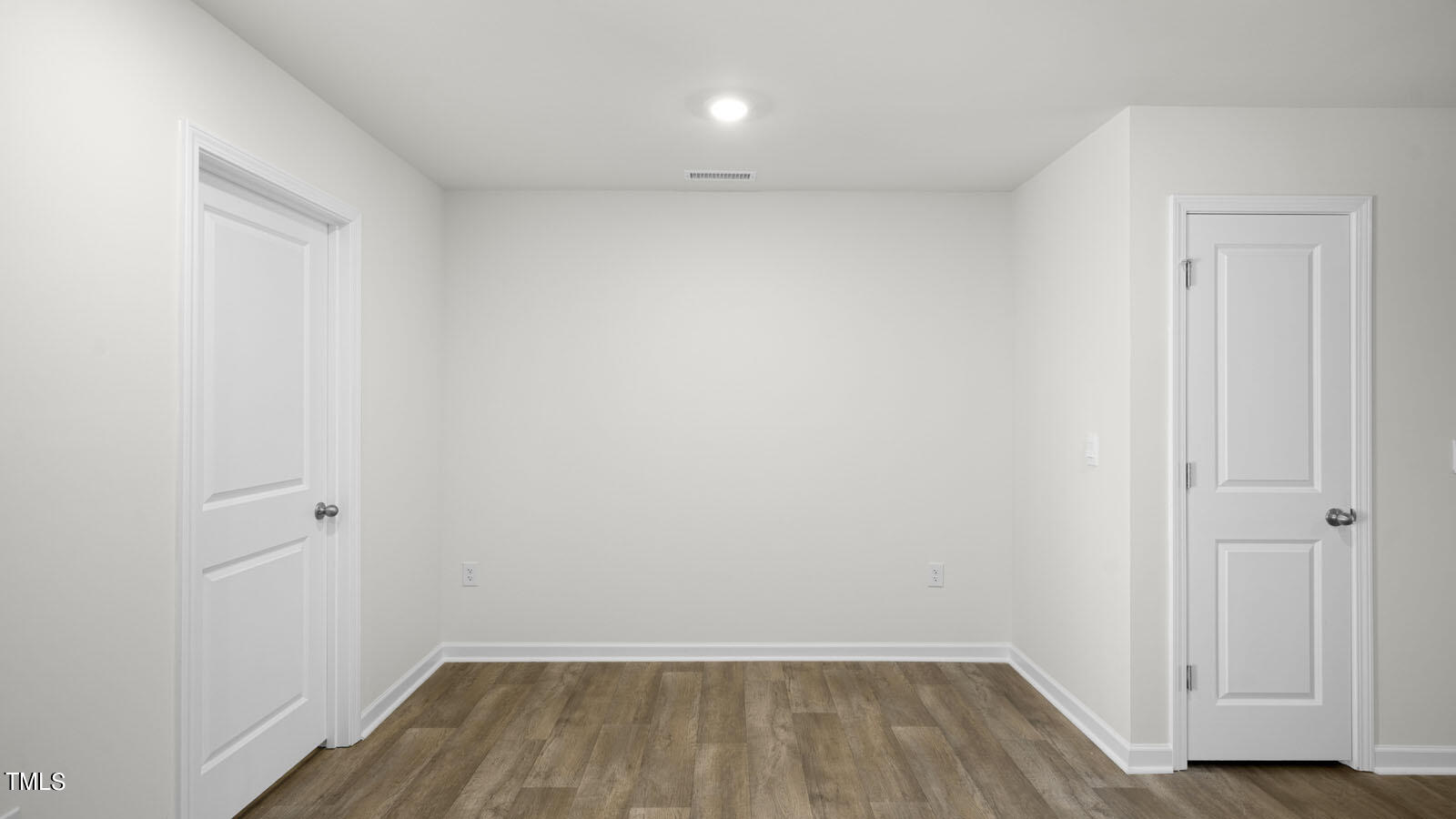 8741 Asher Gray Way Raleigh, NC 27616 - Photo 33 of 49 a view of a room with wooden floor and white doors