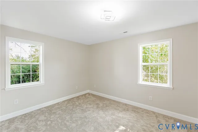 a view of a big room with closet and windows