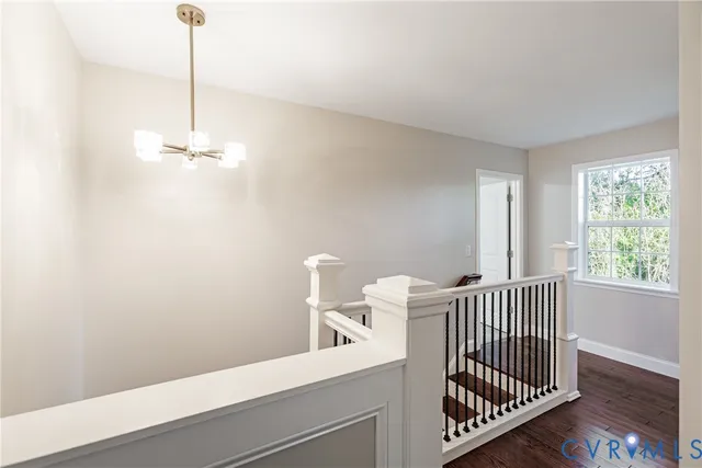 a bathroom with a granite countertop sink a toilet and a window