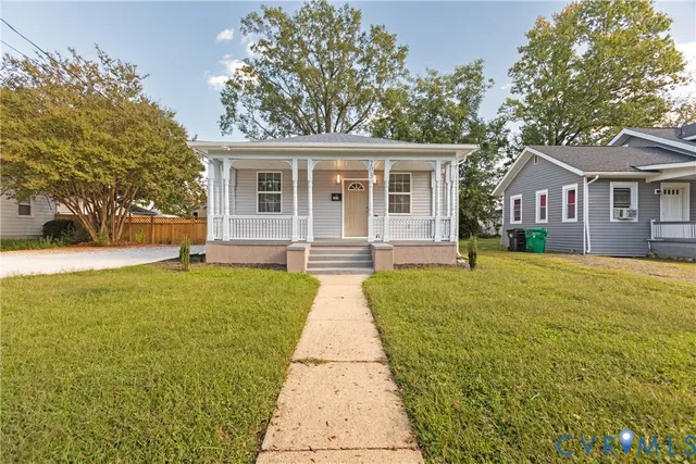 a front view of a house with yard and green space