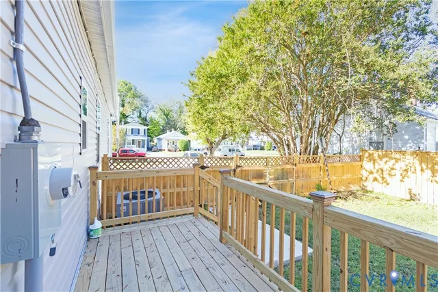 a view of balcony with wooden floor and outdoor seating