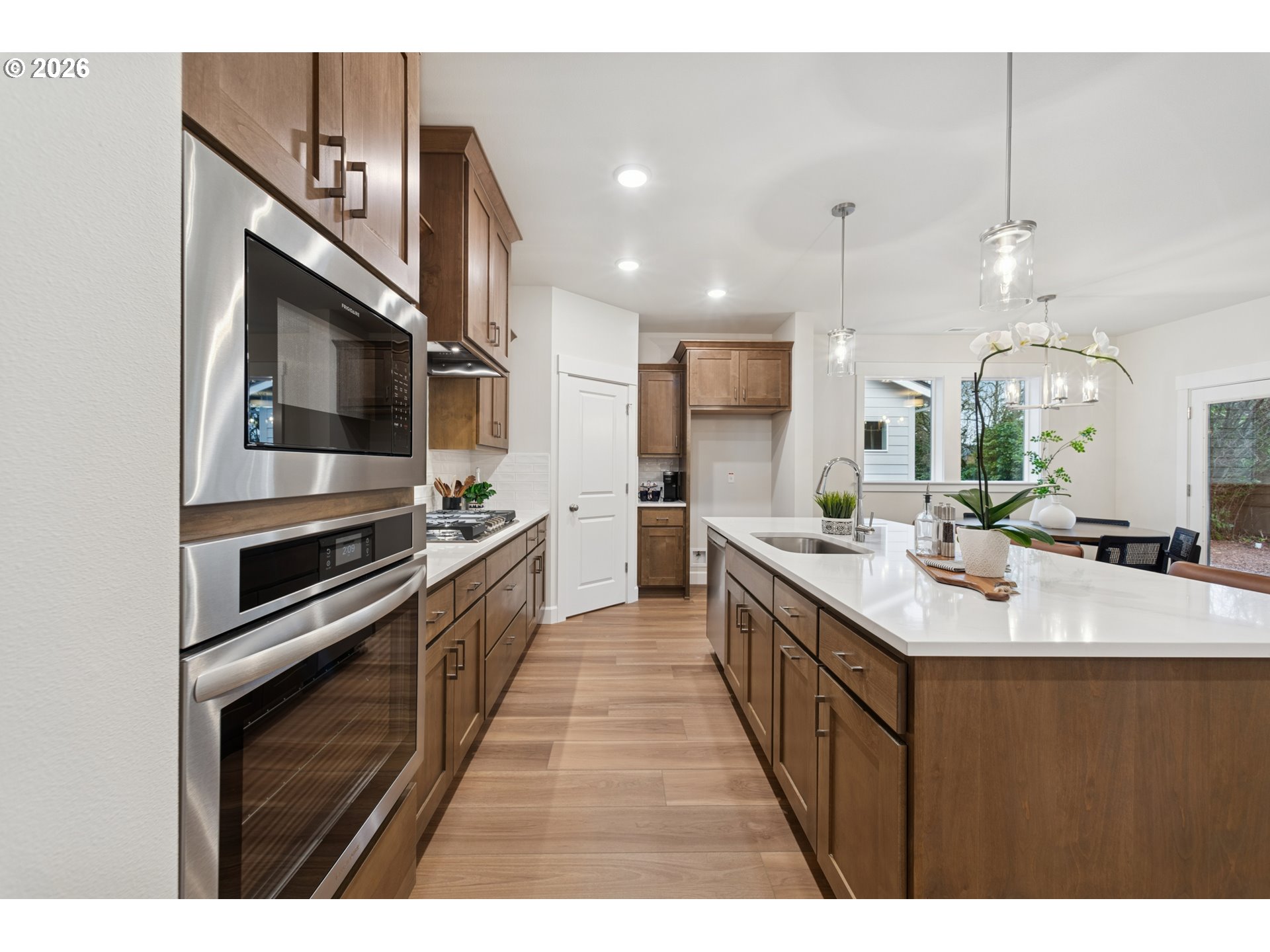 16546 Southwest Deer Terrace Durham, OR 97224 - Photo 11 of 26 a large kitchen with stainless steel appliances kitchen island a large counter space a sink and cabinets
