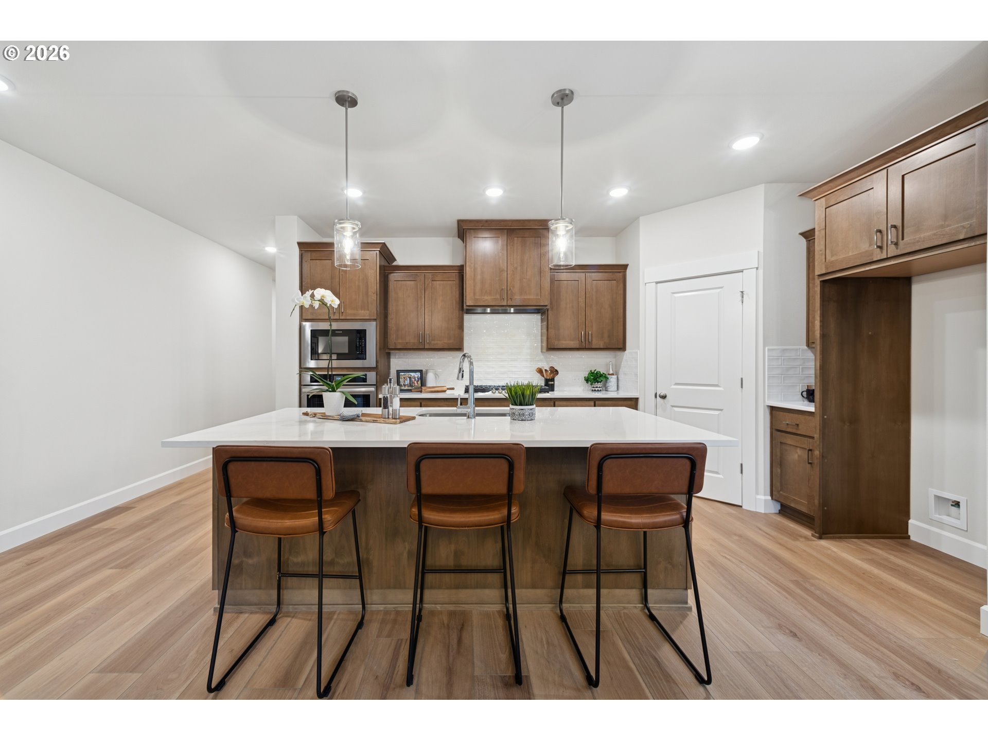 16546 Southwest Deer Terrace Durham, OR 97224 - Photo 12 of 26 a kitchen with kitchen island wooden cabinets and refrigerator
