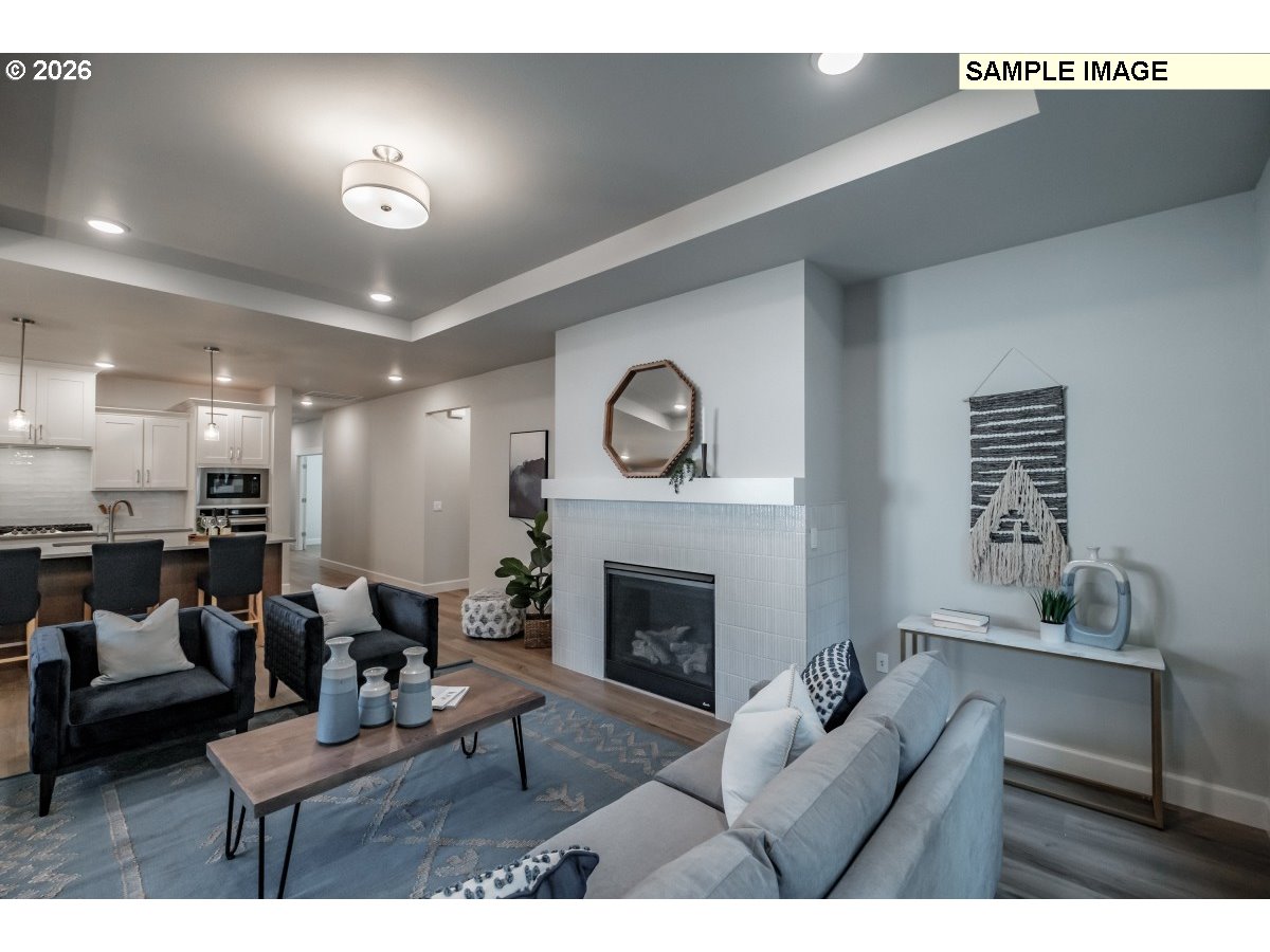 16546 Southwest Deer Terrace Durham, OR 97224 - Photo 3 of 26 a living room with furniture a fireplace and a flat screen tv