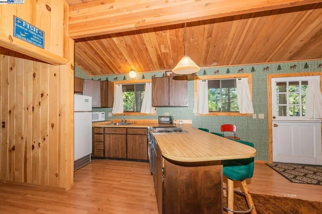 a kitchen with stainless steel appliances a table and chairs