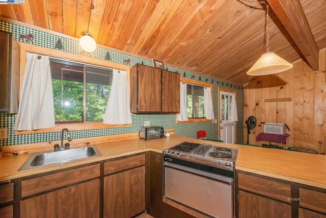 a kitchen that has a sink and a stove