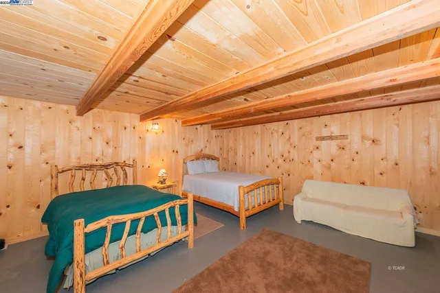 a bedroom with two beds and a chandelier