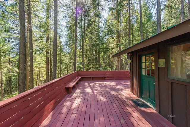 a view of balcony with wooden floor and fence