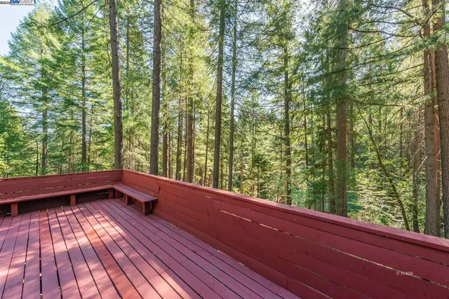 a view of balcony with wooden floor and fence