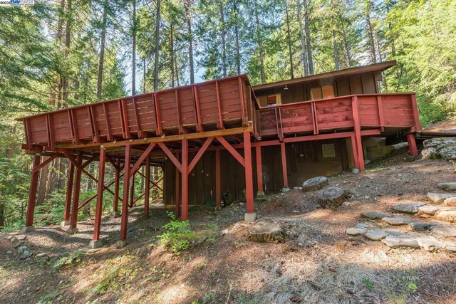 a backyard of a house with table and chairs