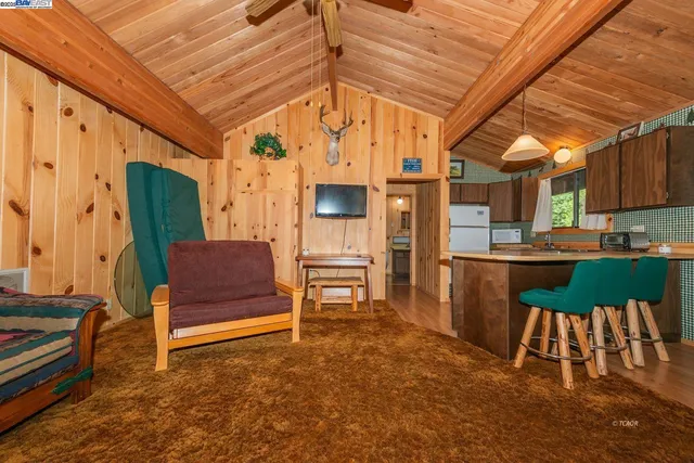a view of kitchen with furniture and a refrigerator