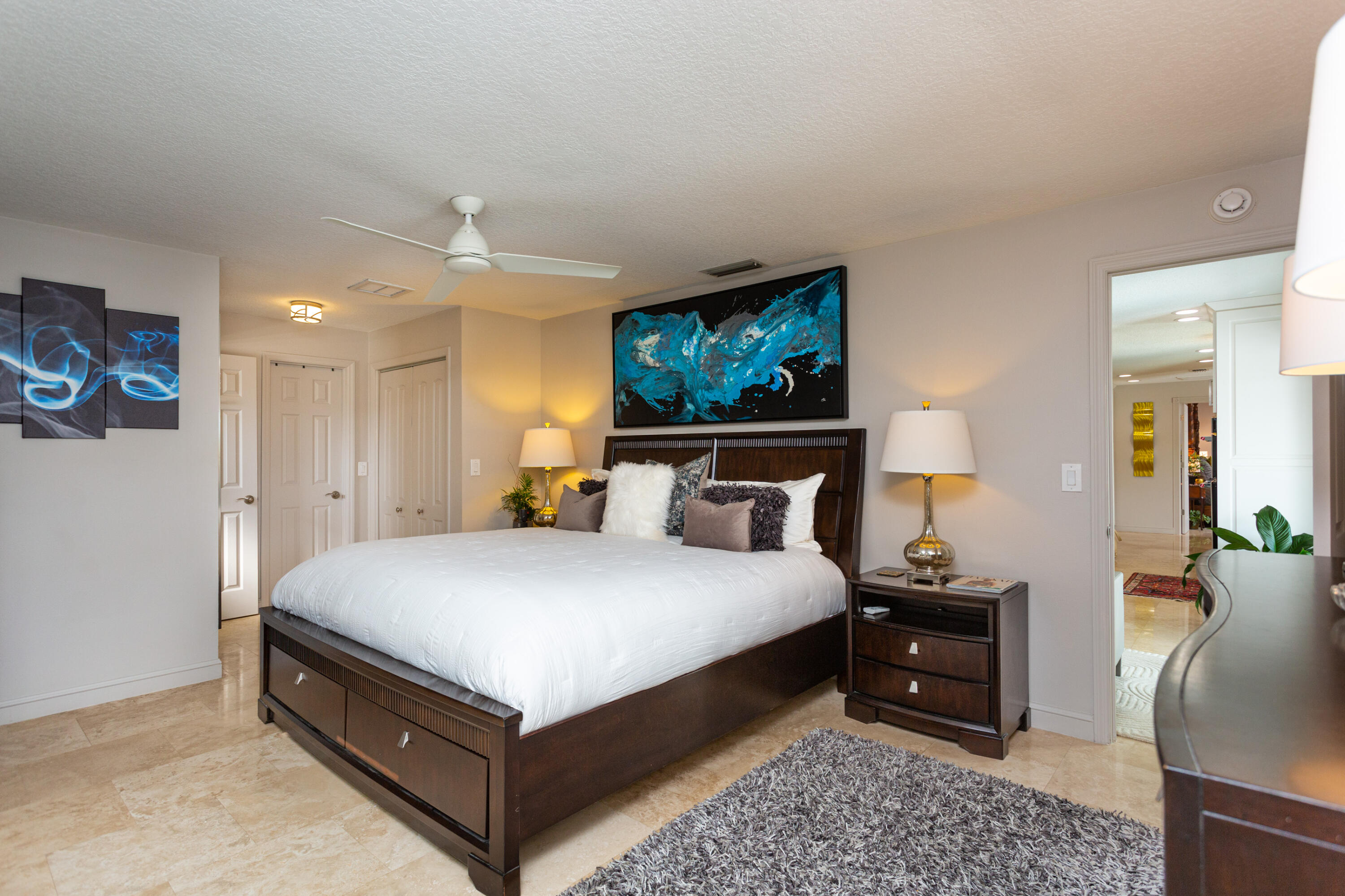 4 Country Club Road Cocoa Beach, FL 32931 - Photo 18 of 38 a spacious bedroom with a bed and a couch