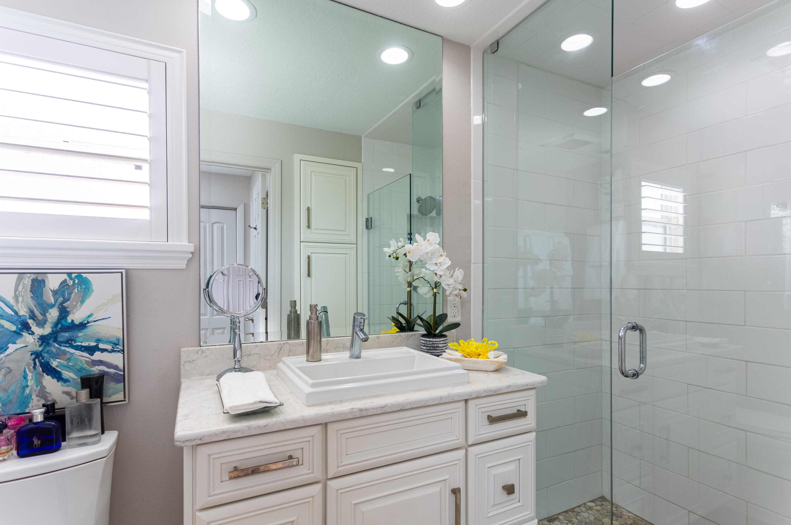 4 Country Club Road Cocoa Beach, FL 32931 - Photo 20 of 38 a bathroom with a granite countertop sink a toilet a mirror and shower