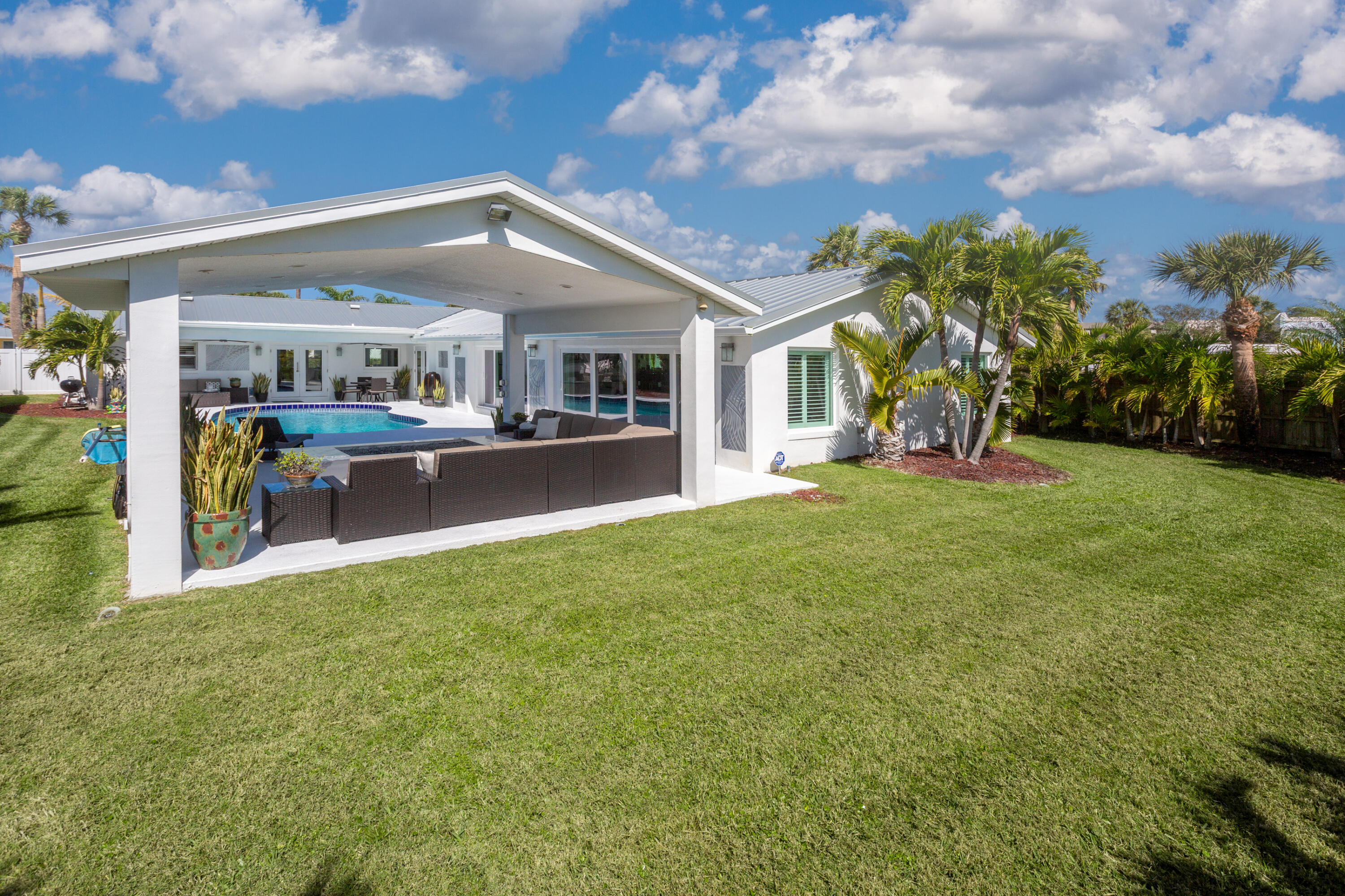 4 Country Club Road Cocoa Beach, FL 32931 - Photo 27 of 38 a view of a house with a yard and sitting area