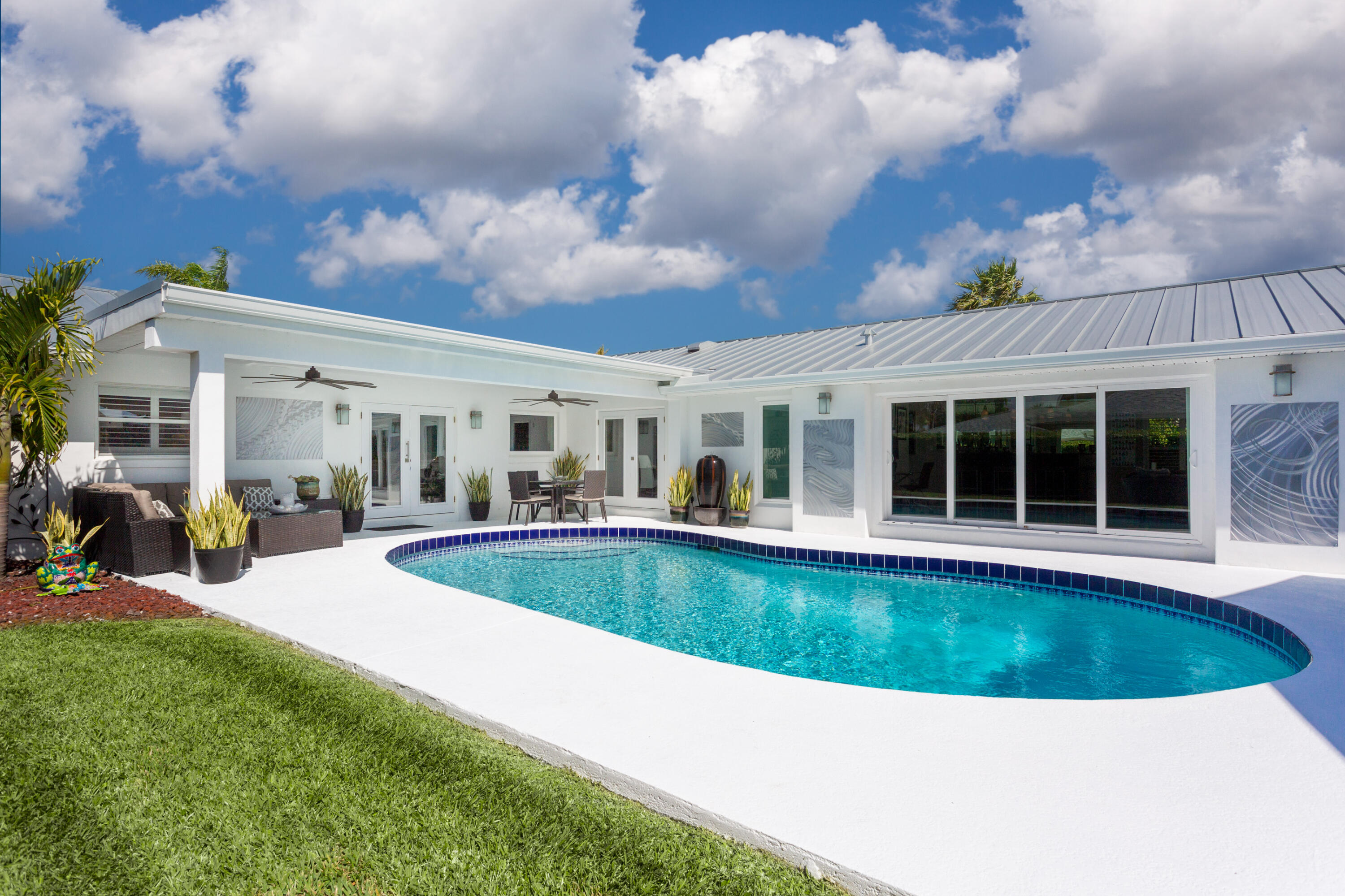 4 Country Club Road Cocoa Beach, FL 32931 - Photo 3 of 38 a view of a house with swimming pool and sitting area