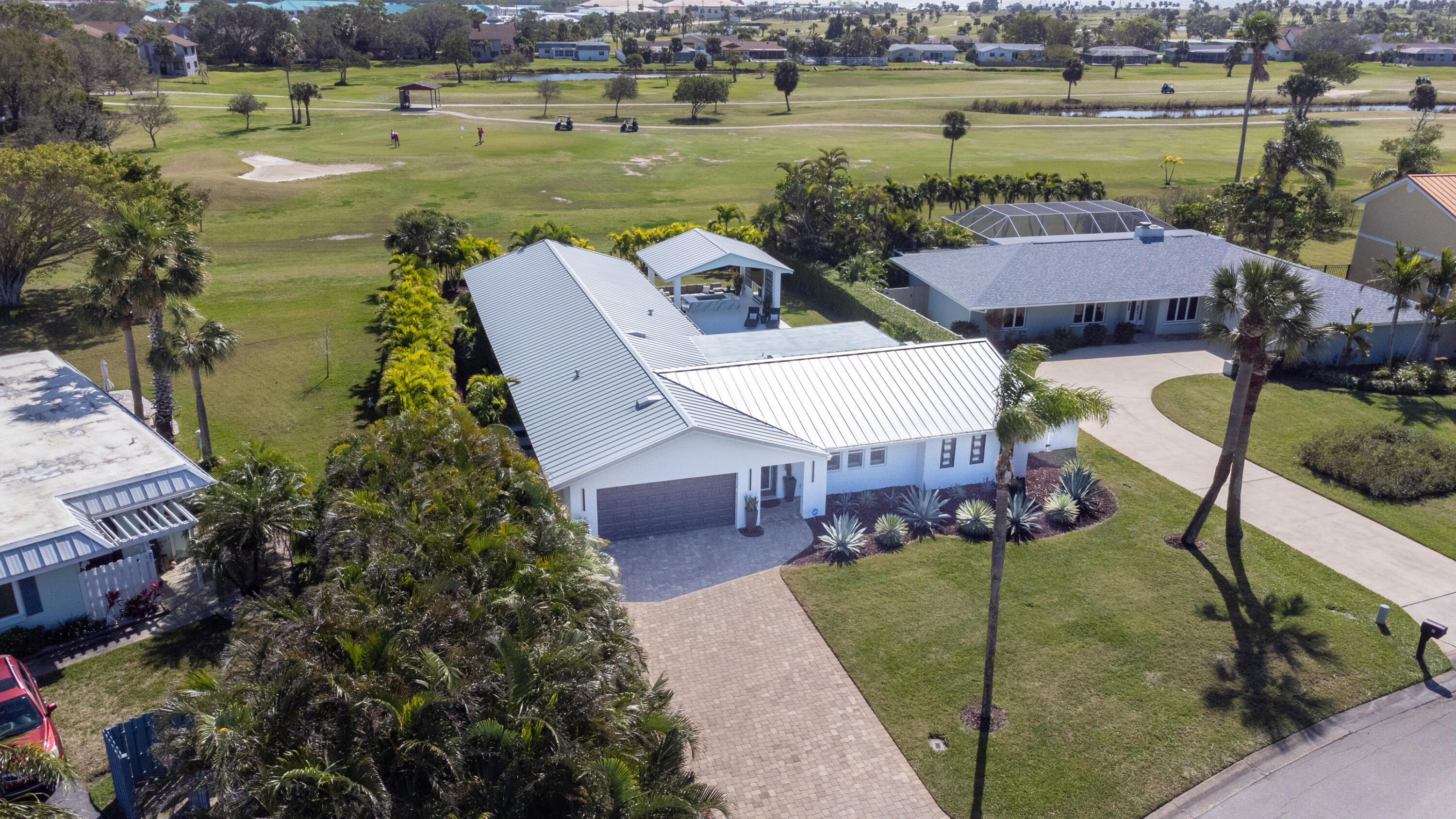 4 Country Club Road Cocoa Beach, FL 32931 - Photo 35 of 38 a view of a lake with couches chair and table in the patio