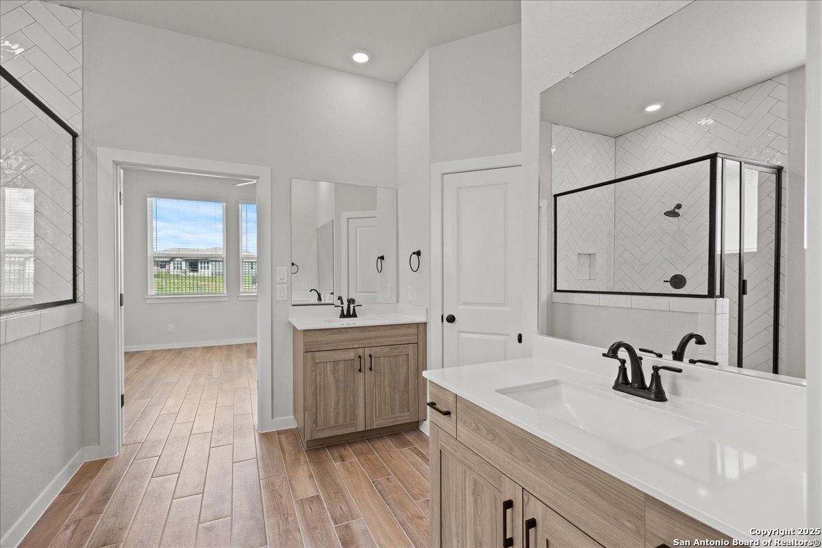 2122 Shepards Street Seguin, TX 78155 - Photo 20 of 28 a spacious bathroom with a double vanity sink a mirror and a bathtub