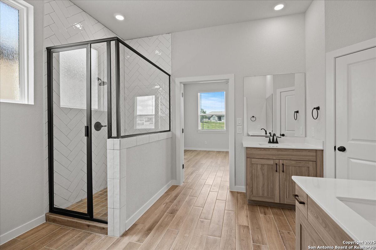 2122 Shepards Street Seguin, TX 78155 - Photo 21 of 28 a bathroom with a granite countertop sink mirror and refrigerator