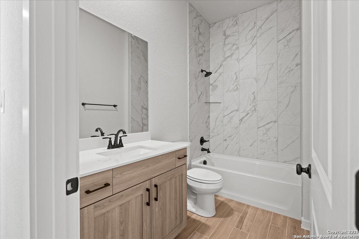 2122 Shepards Street Seguin, TX 78155 - Photo 22 of 28 a bathroom with a sink a toilet and a tub