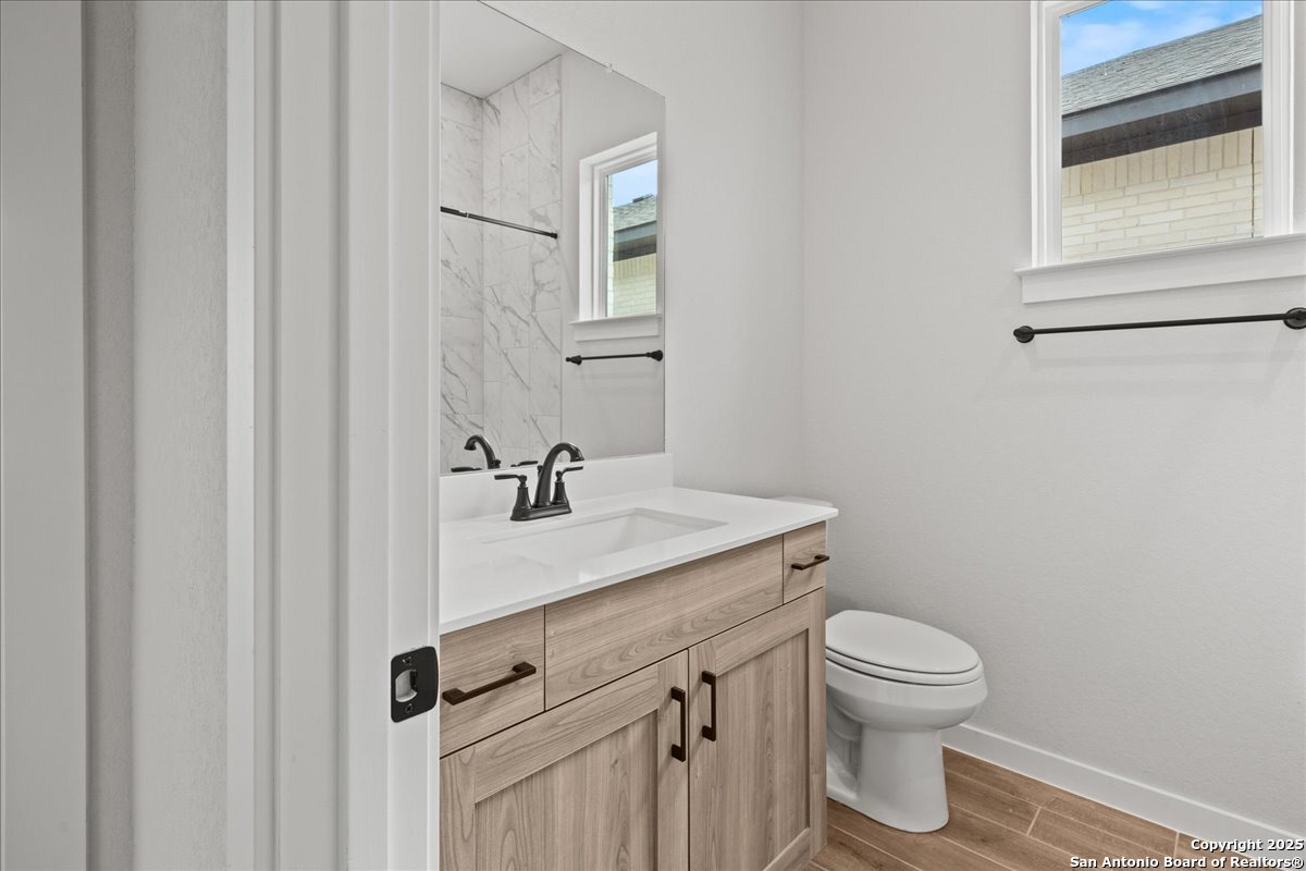 2122 Shepards Street Seguin, TX 78155 - Photo 23 of 28 a bathroom with a sink a toilet and a mirror