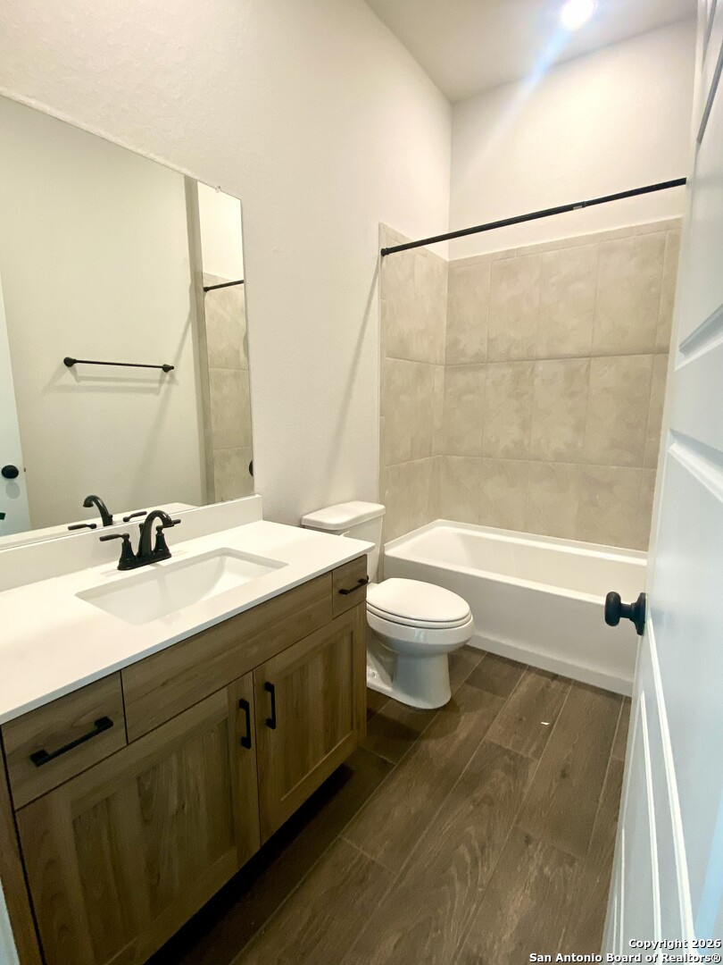 2122 Shepards Street Seguin, TX 78155 - Photo 7 of 28 a bathroom with a bathtub shower sink vanity mirror and toilet