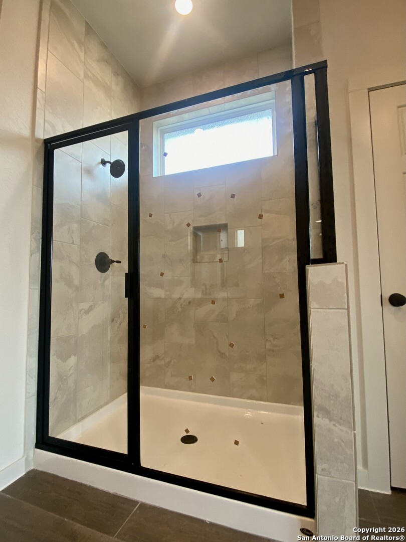 2122 Shepards Street Seguin, TX 78155 - Photo 9 of 28 a bathroom with a glass shower door
