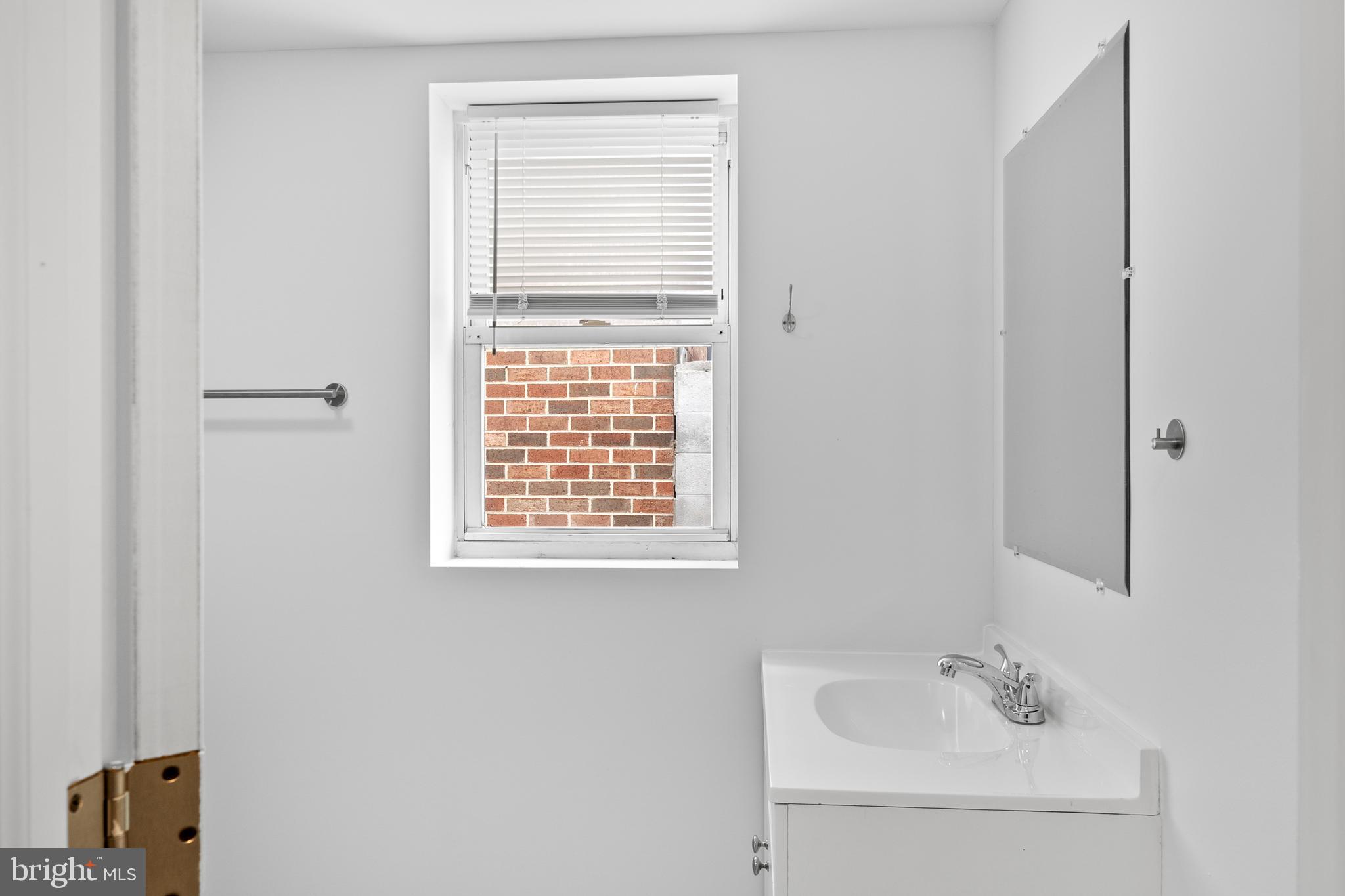 2652 Bridge Street Philadelphia, PA 19137 - Photo 13 of 18 a bathroom with a sink a vanity and a window