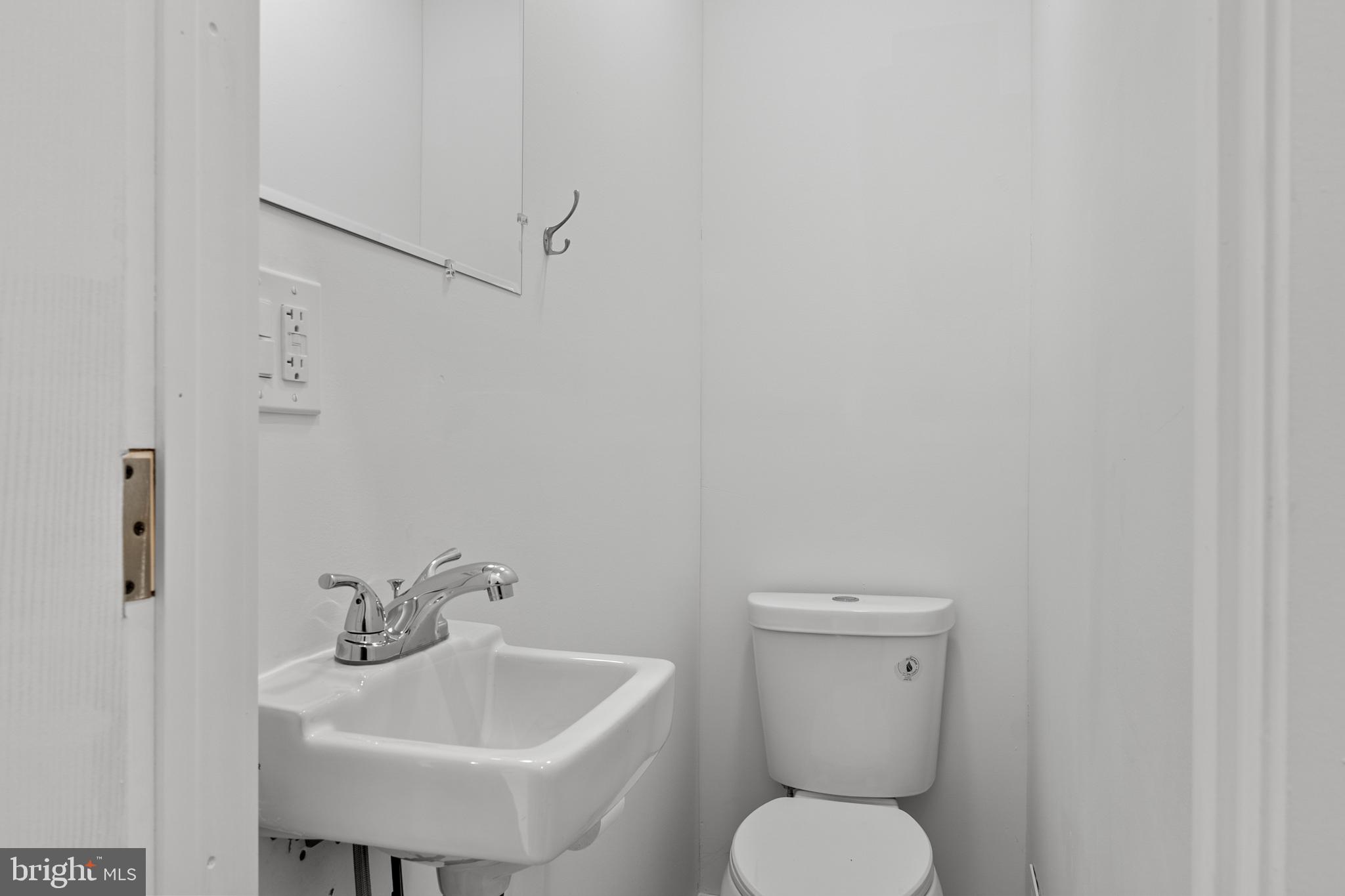 2652 Bridge Street Philadelphia, PA 19137 - Photo 5 of 18 a bathroom with a toilet sink and mirror