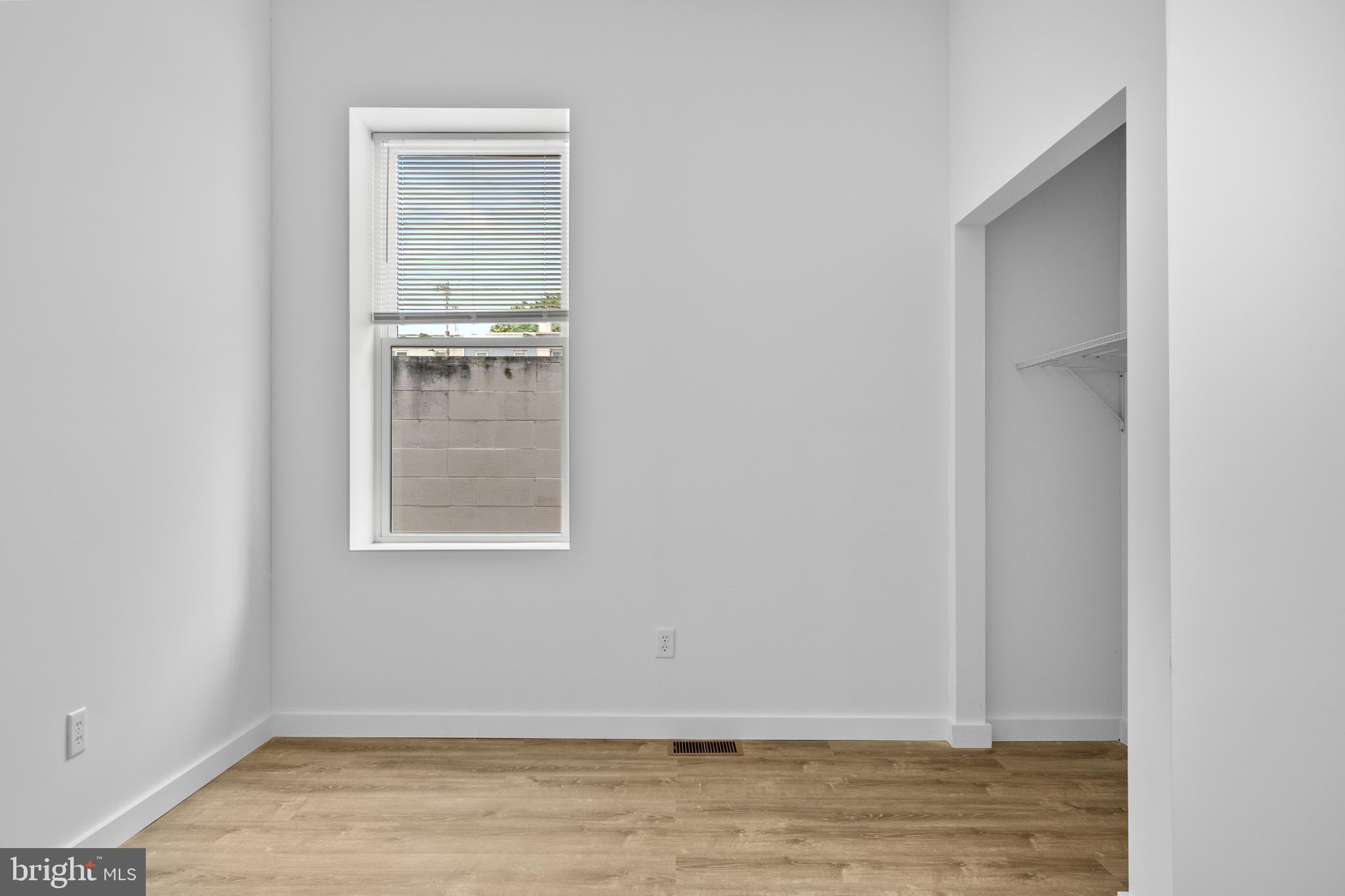 2652 Bridge Street Philadelphia, PA 19137 - Photo 10 of 18 a view of an empty room with wooden floor and a window