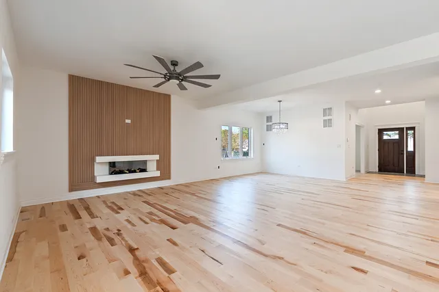 a view of an empty room with a fireplace and a window
