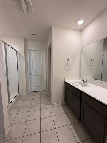 a bathroom with a sink a mirror and a shower