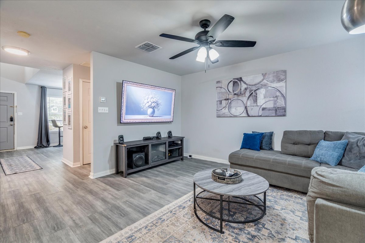 148 Buttercup Way Kyle, TX 78640 - Photo 6 of 33 Living area featuring a ceiling fan and light wood-style floors