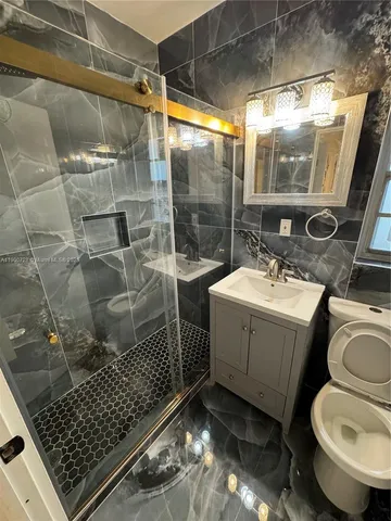 a bathroom with a sink toilet and shower