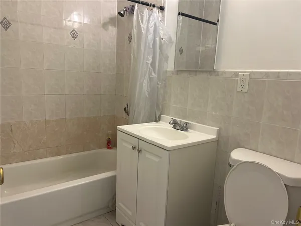 a bathroom with a sink a toilet and bathtub