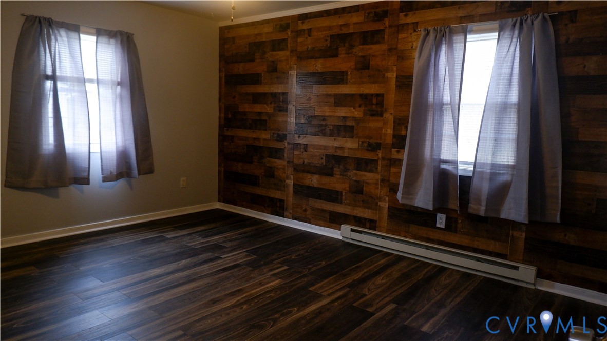 4524 Twelveoaks Road Midlothian, VA 23112 - Photo 6 of 12 a view of an empty room with wooden floor and a window