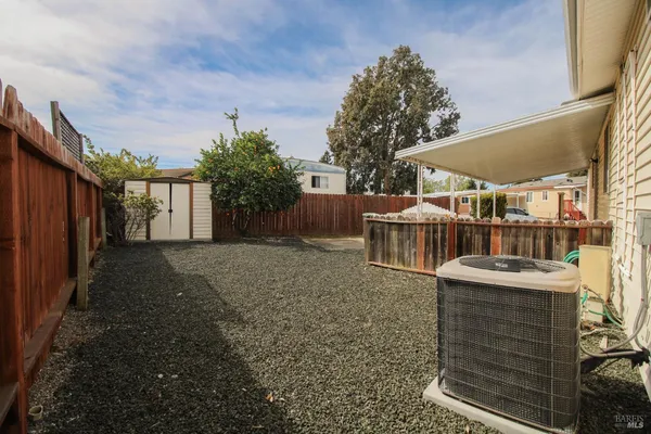 a view of a backyard with wooden fence