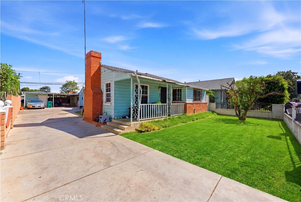121 East 68th Way Long Beach, CA 90805 - Photo 2 of 17 a view of a house with backyard and a tree