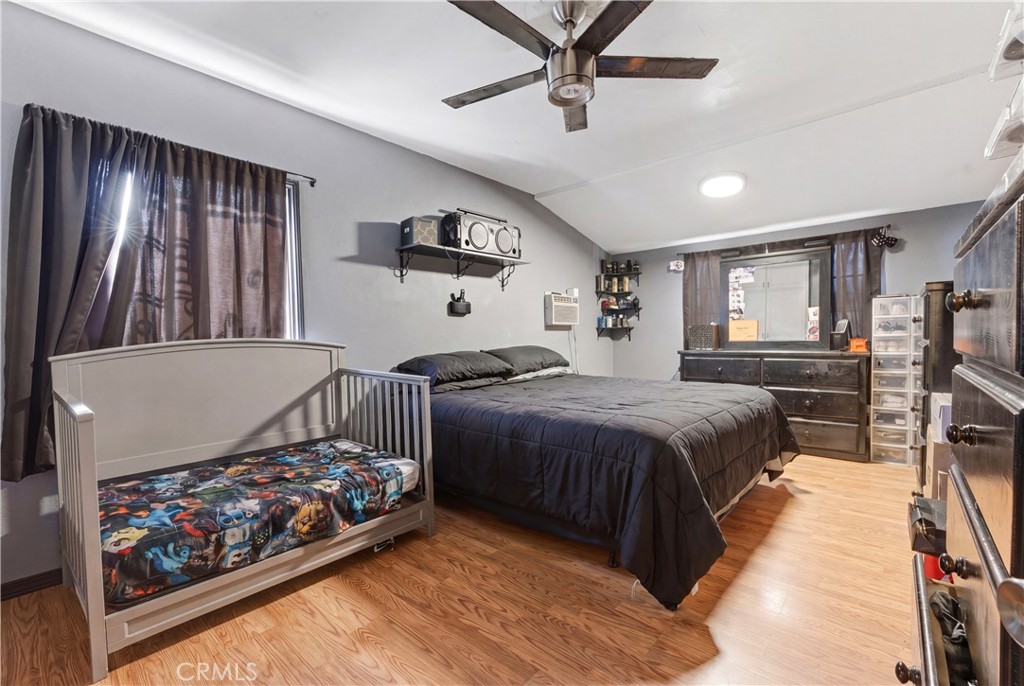 121 East 68th Way Long Beach, CA 90805 - Photo 8 of 17 a bedroom with a bed and a large window