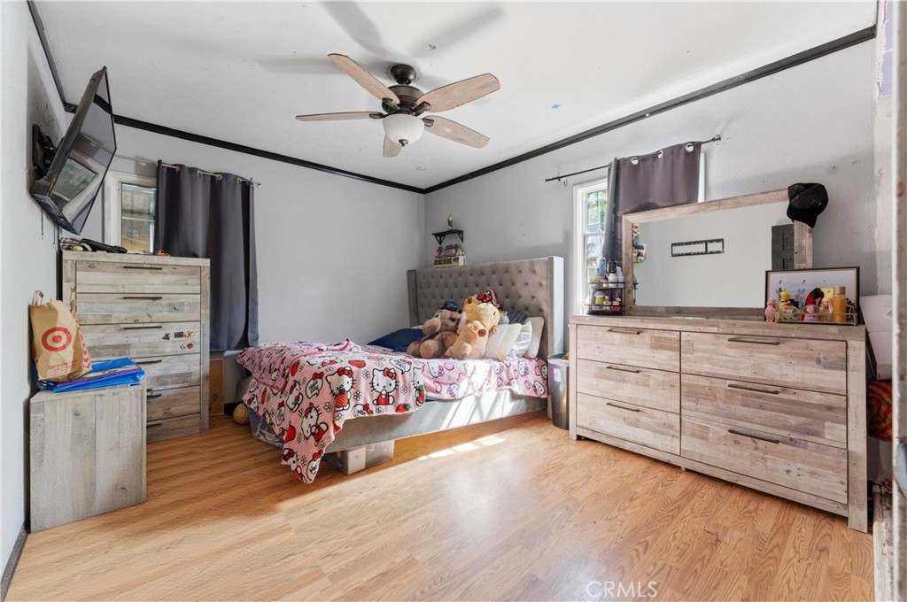 121 East 68th Way Long Beach, CA 90805 - Photo 9 of 17 a bedroom with a bed and wooden floor