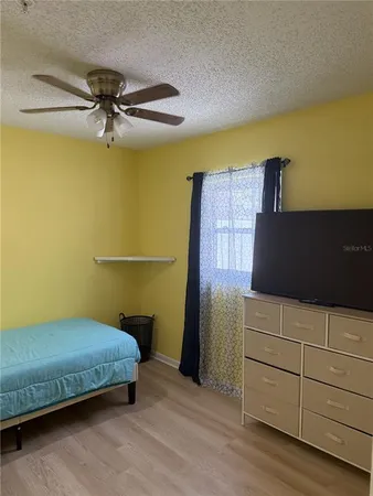 a bedroom with a bed and cabinet