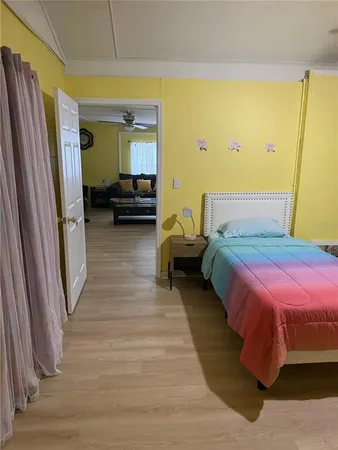 a bedroom with a bed and wooden floor