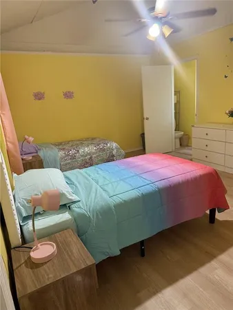 a bedroom with a bed and chandelier