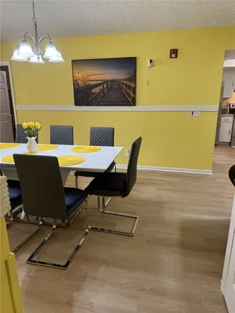 a view of a dining room with furniture and chandelier